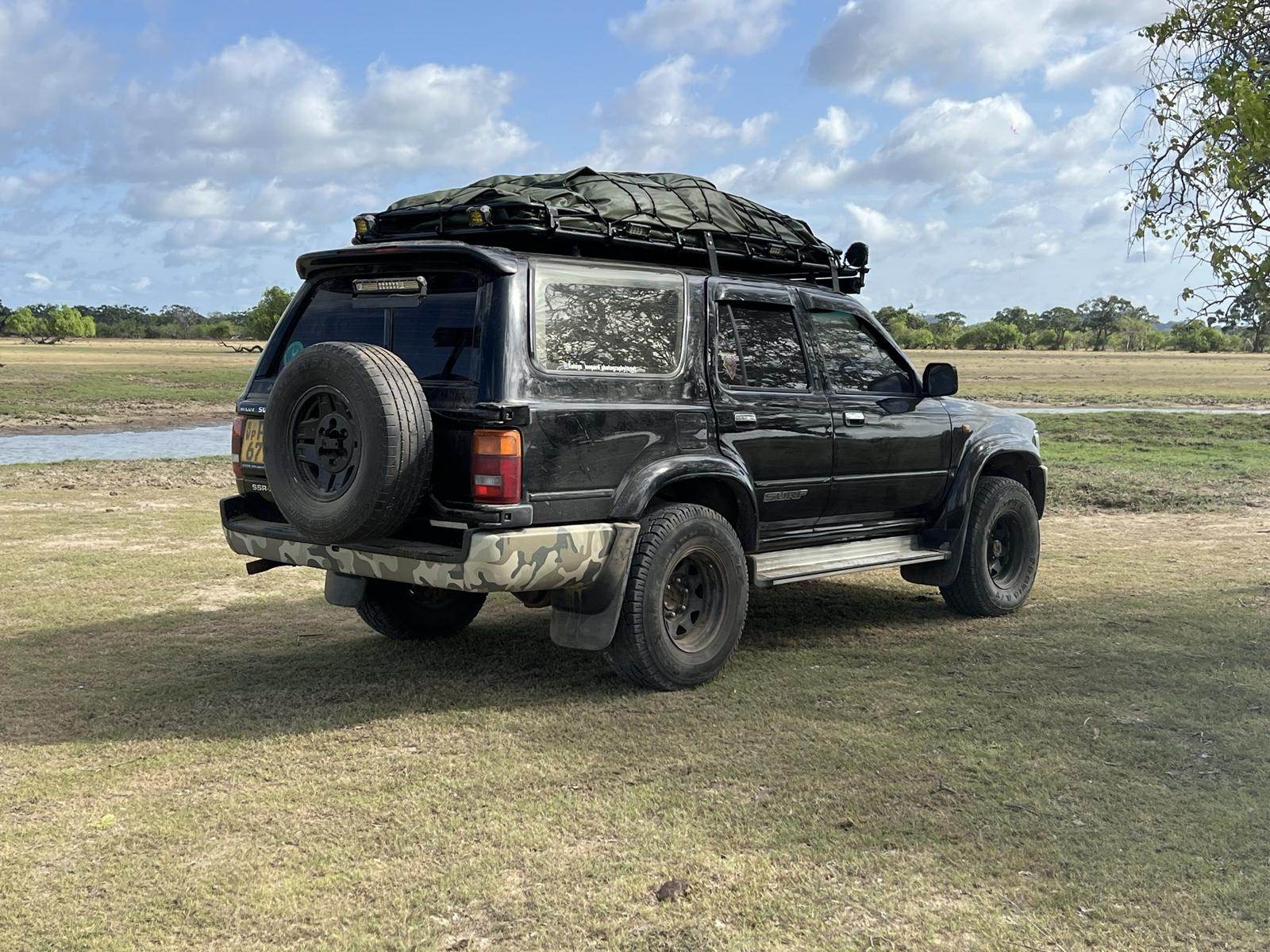 Rear view of the Kelaya Photography safari jeep with roof rack and spare wheel